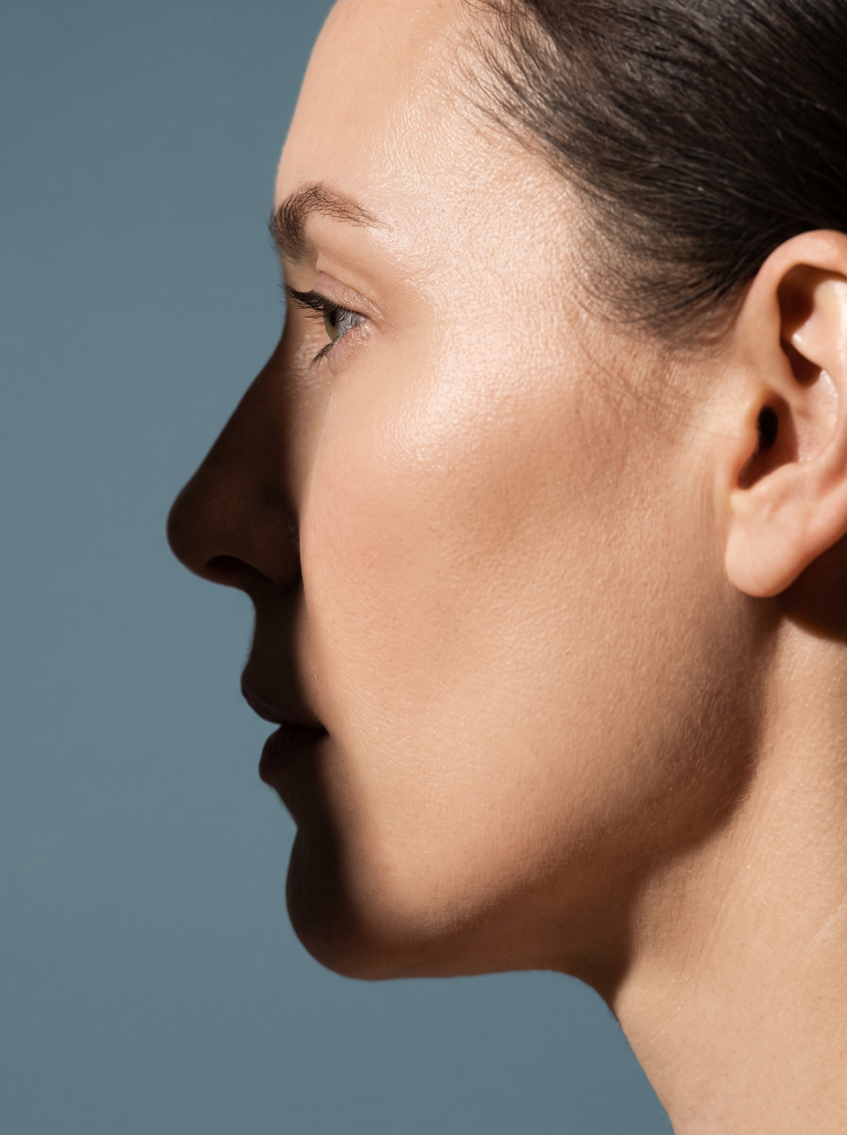 Close-up of an adult's nose and cheek in profile, the oily center of the face where breakouts tend to cluster