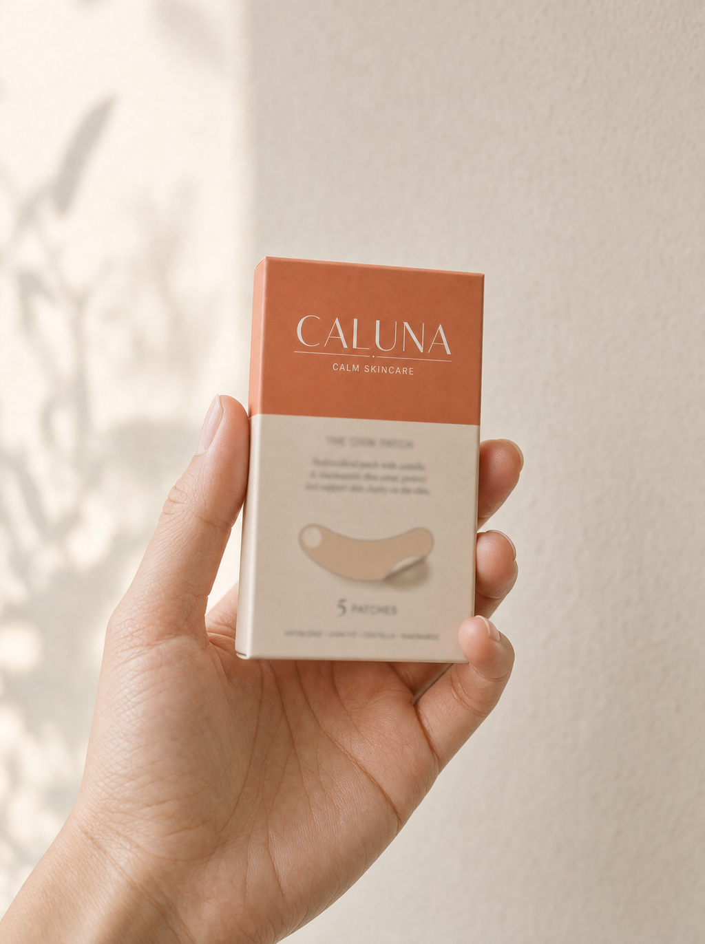 The Chin Patch box held in a hand, showing its palm-sized scale